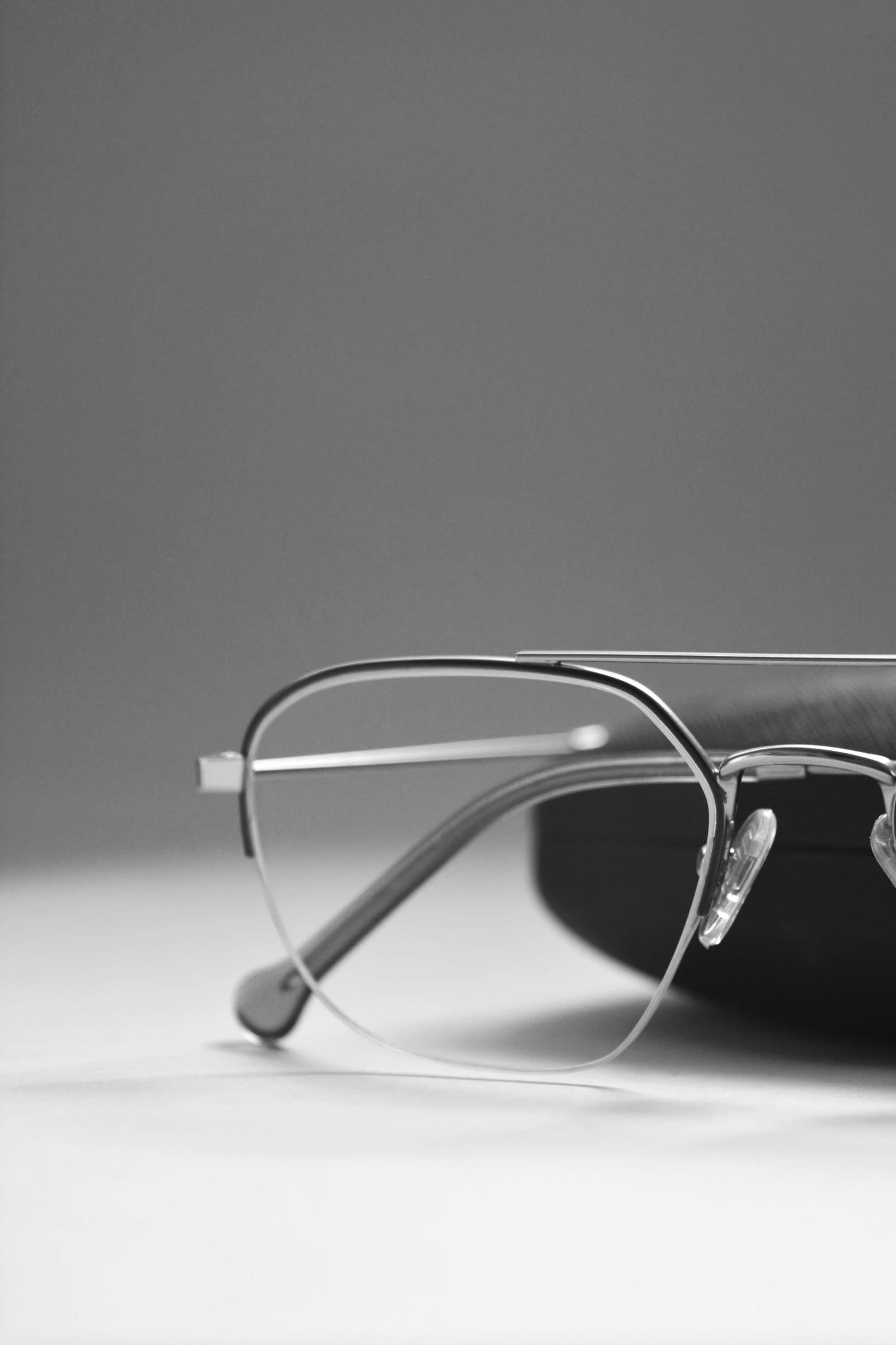 a pair of glasses sitting on top of a white table