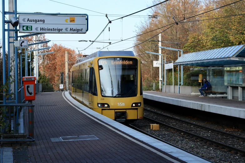 a train traveling down tracks next to a loading platform