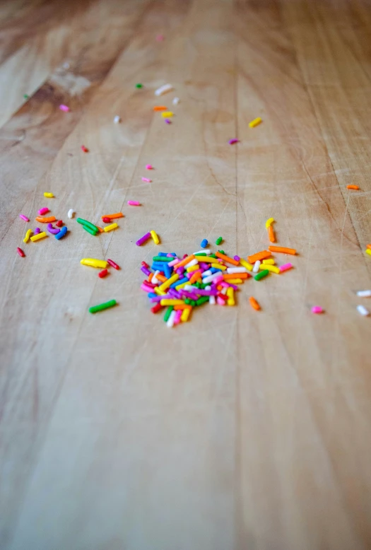 colorful confetti on top of a wooden floor