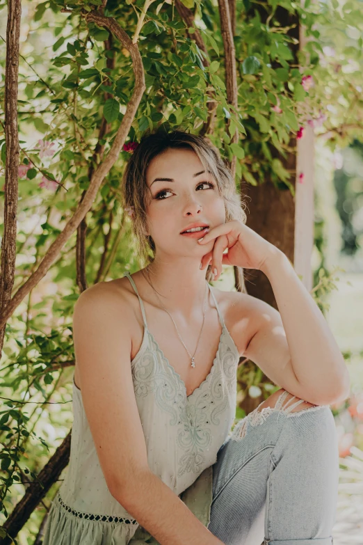 a woman is sitting down with flowers on her head