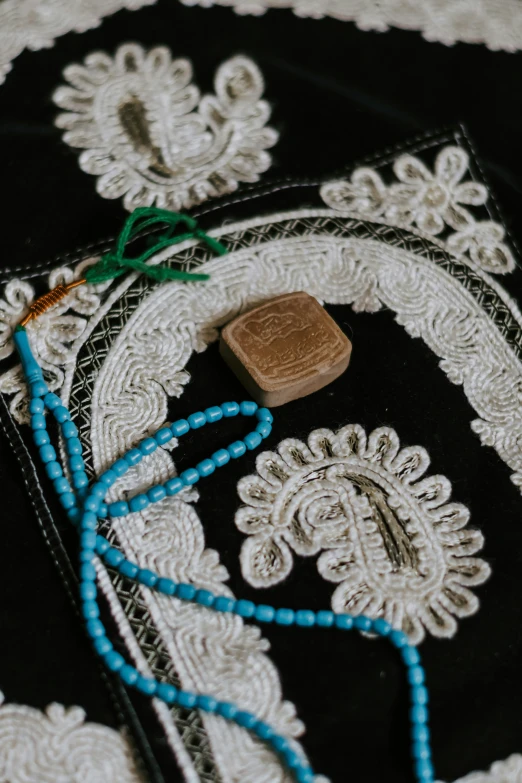 blue string that are tied around a black doily