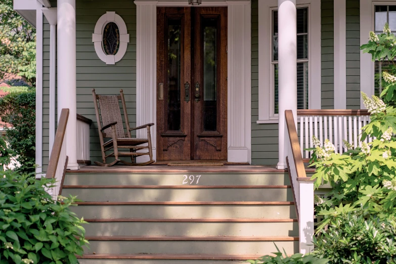 a porch with a rocking chair outside of it