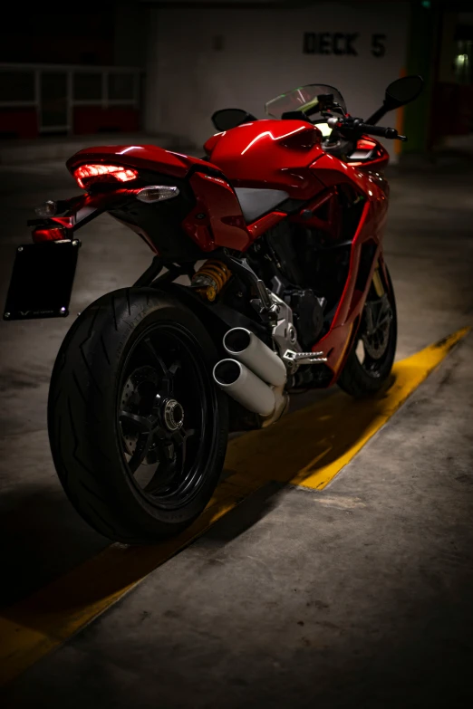 a motorcycle sits parked on the curb in a parking lot