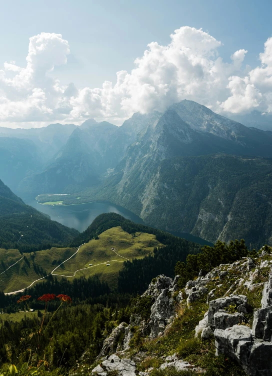 mountains with a lake in the middle are covered with grass and rocks