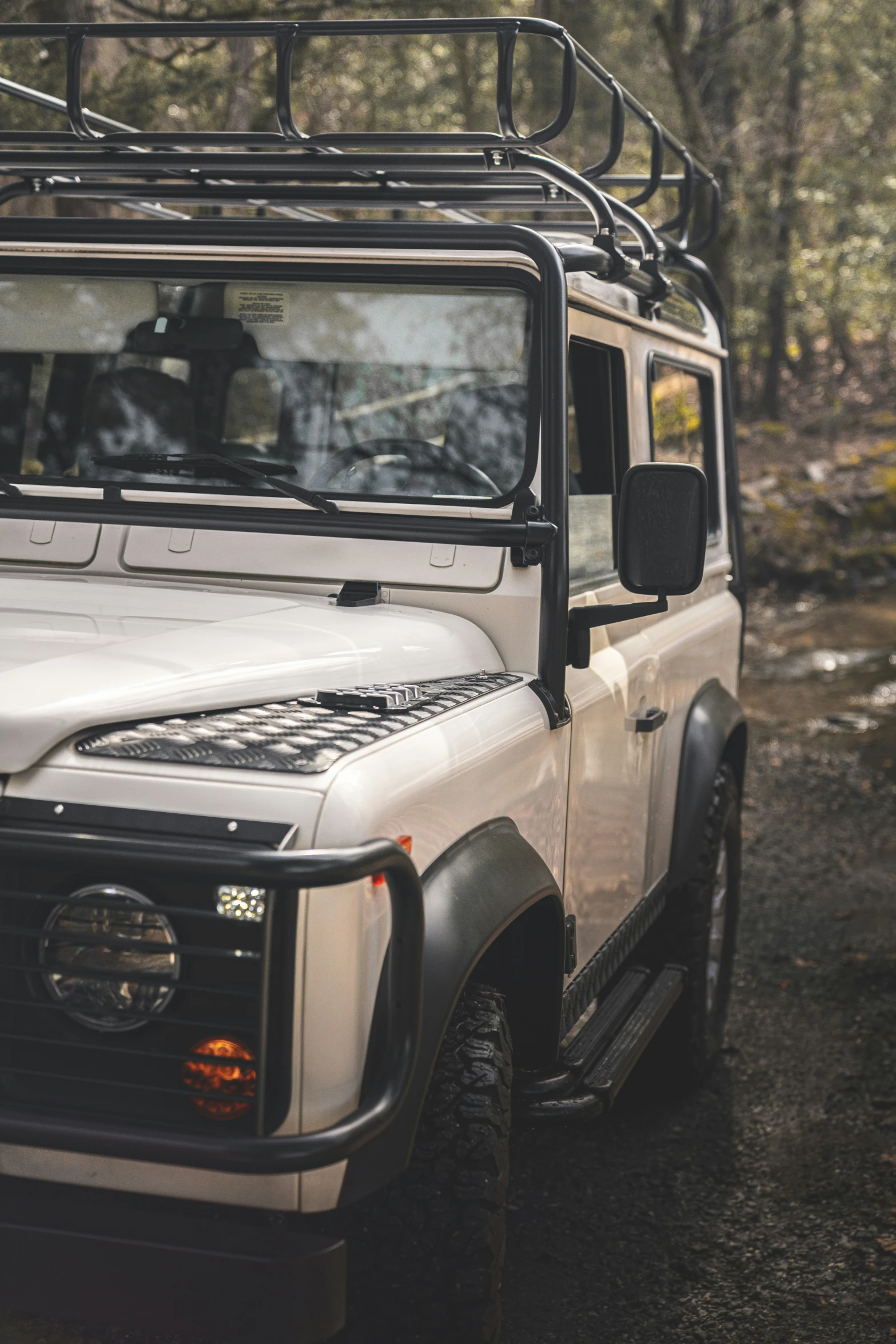 there is a white jeep parked in the woods