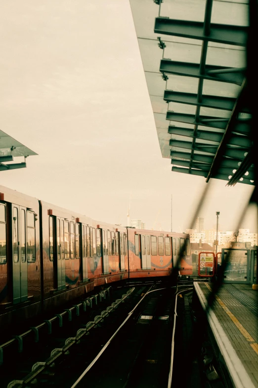 the train is leaving the train station and the train has pulled in