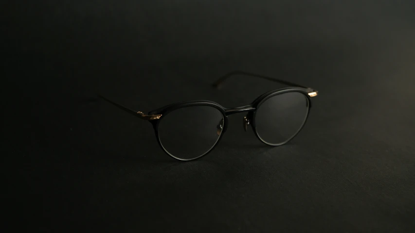 a pair of eyeglasses sitting on top of a black table