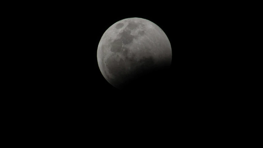 the moon as it sits in the sky with a jet