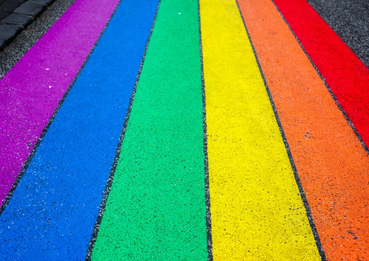 many rainbow colors have been drawn on this sidewalk