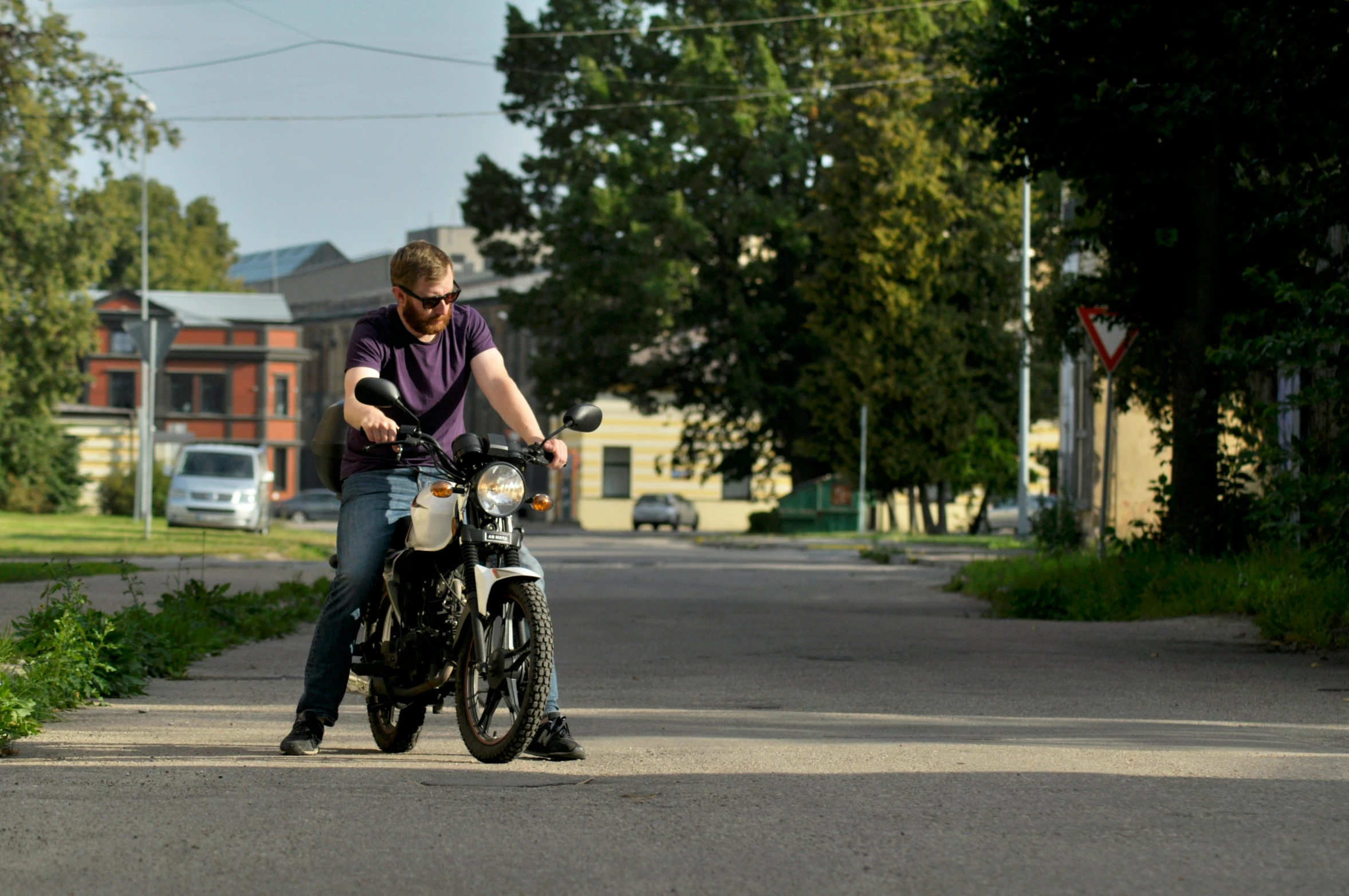 a man on a motor bike riding on the street