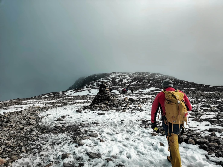 a man standing on top of a snow covered hill