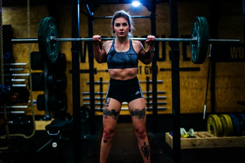 a female weightlifter posing for the camera