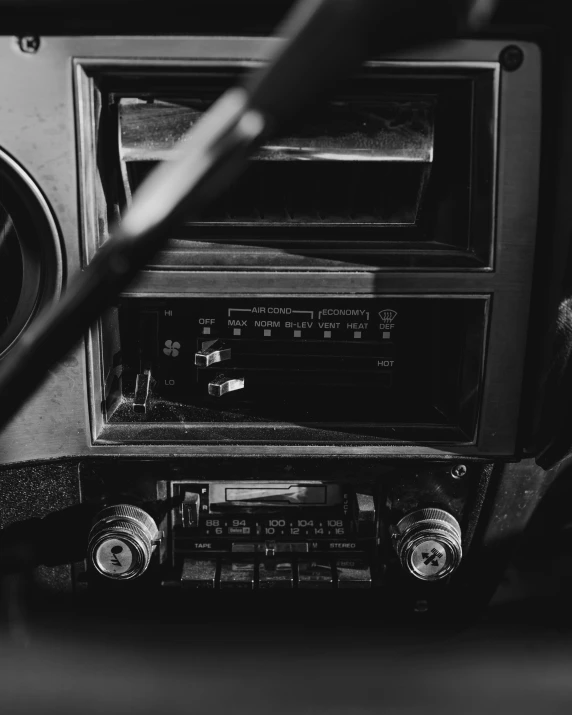 an old car radio is sitting with the door open