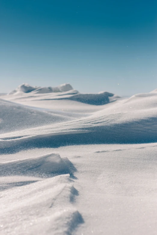 a person riding skis on top of a snow covered slope