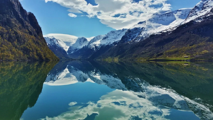 a lake with mountains surrounding it in the middle of it