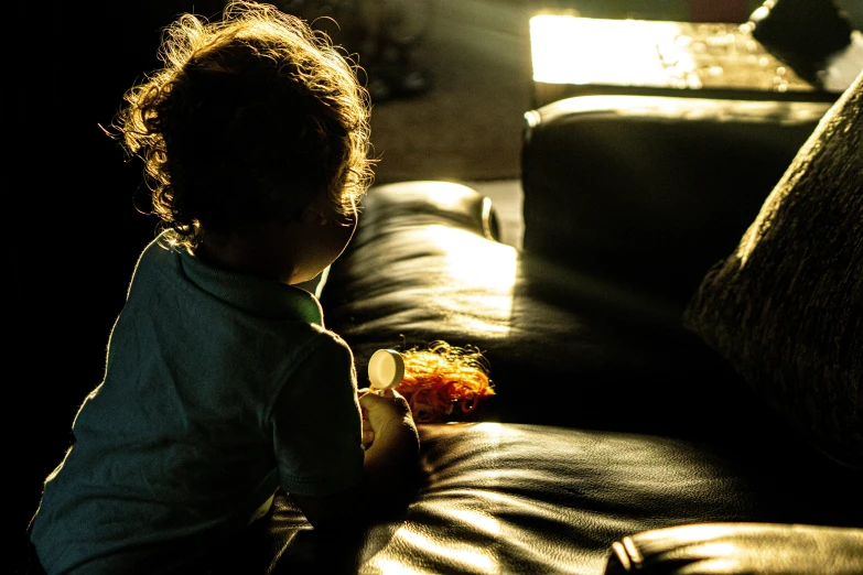 a little boy eating some food with his hands