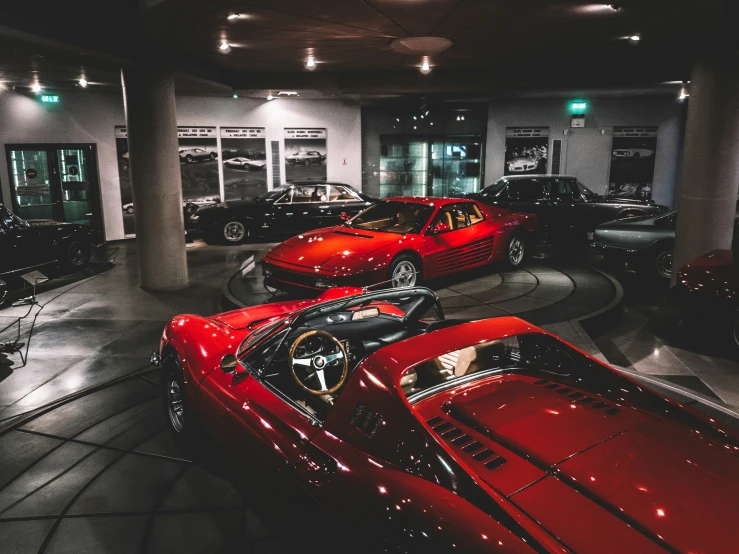 a lot of luxury cars that are sitting in a garage