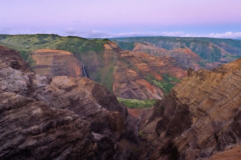 the colorful mountains have trees growing on them