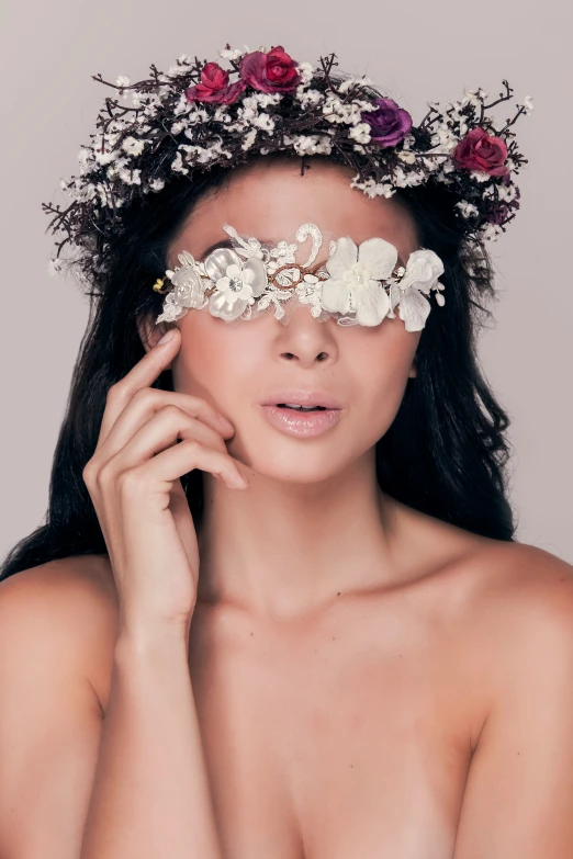 a  girl with flowers is posing for the camera