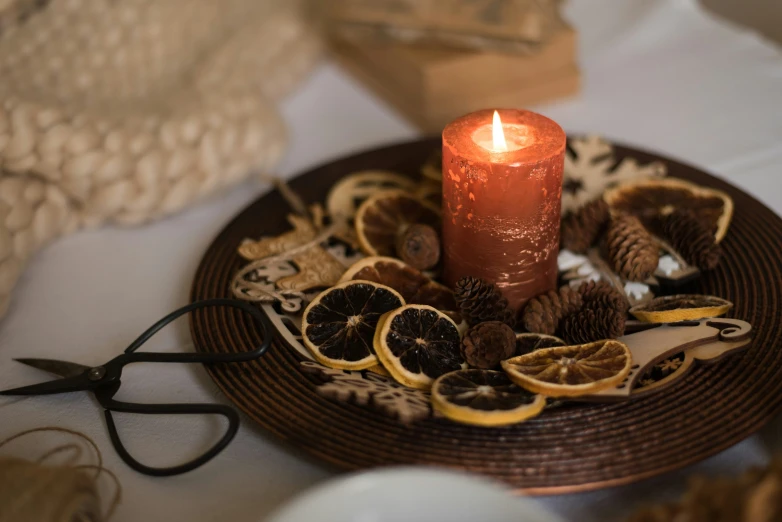 a lit orange on top of a plate