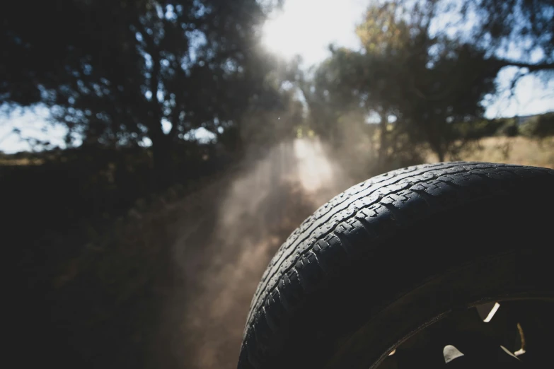 an overcast day with sunbeam and the top part of a tire