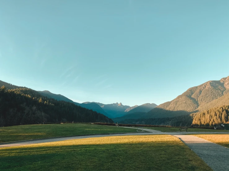 a scenic view of a road passing between mountains