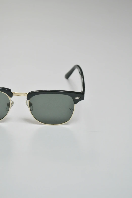 a black pair of sunglasses on a white table