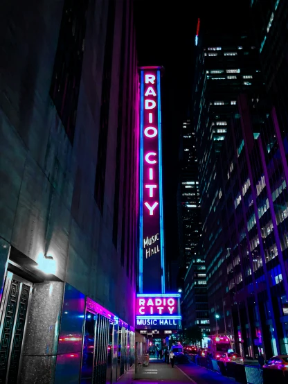 there is a brightly lit radio city sign in the city