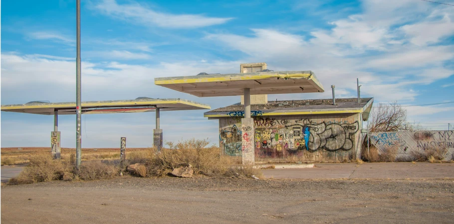 several cement structures sitting on the ground by a bunch of weeds