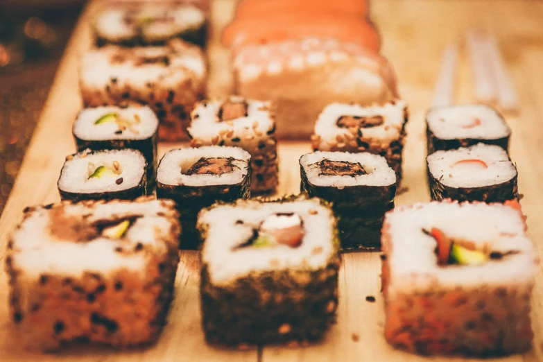 a wooden table topped with different types of sushi