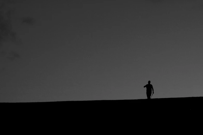 a man is standing in a vast plain alone