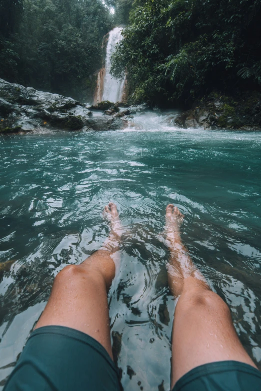 view from water boat that person floating in the water near a waterfall