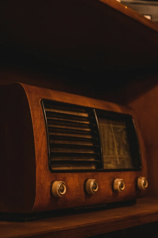 a radio and the speaker has wood and metal in it