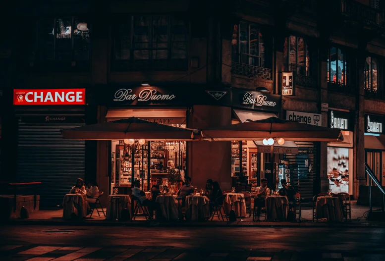 a dimly lit street in front of several shops