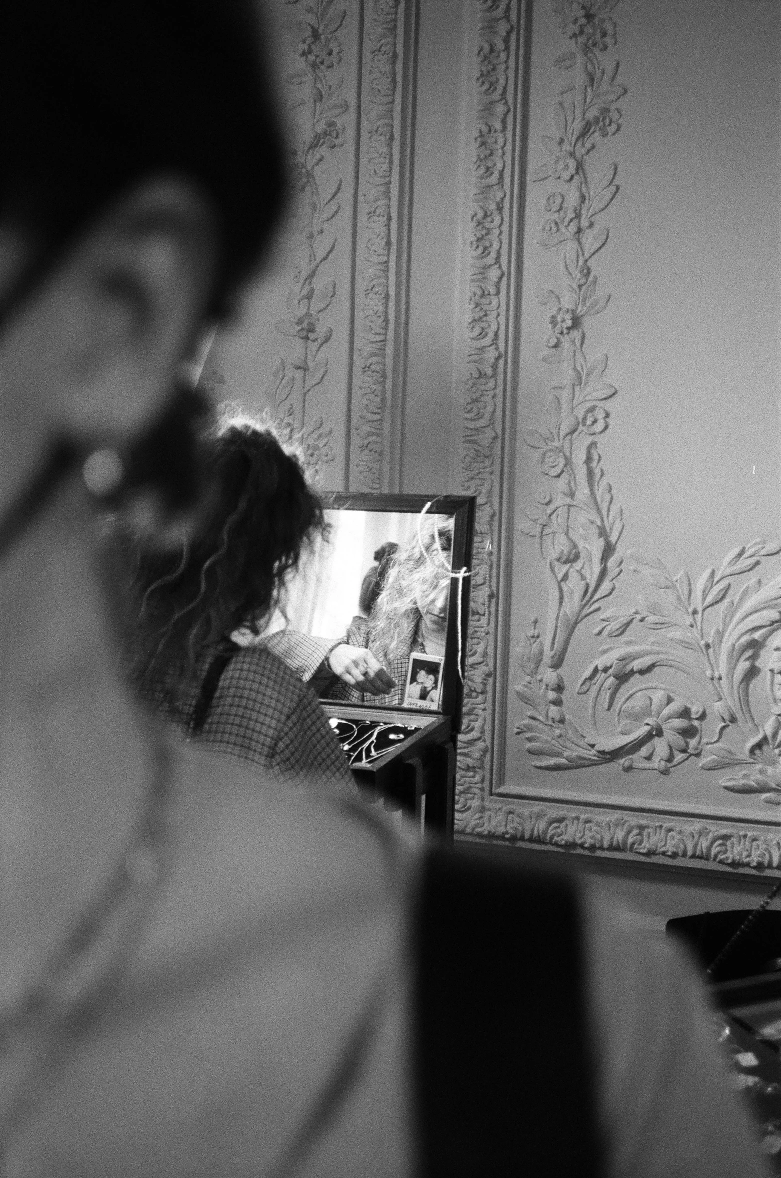 a person is looking into a mirror that is sitting on a counter