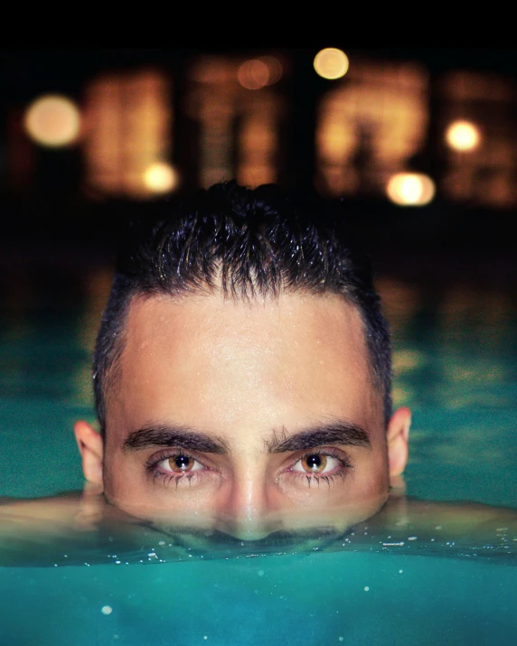 an individual swimming in the water near buildings