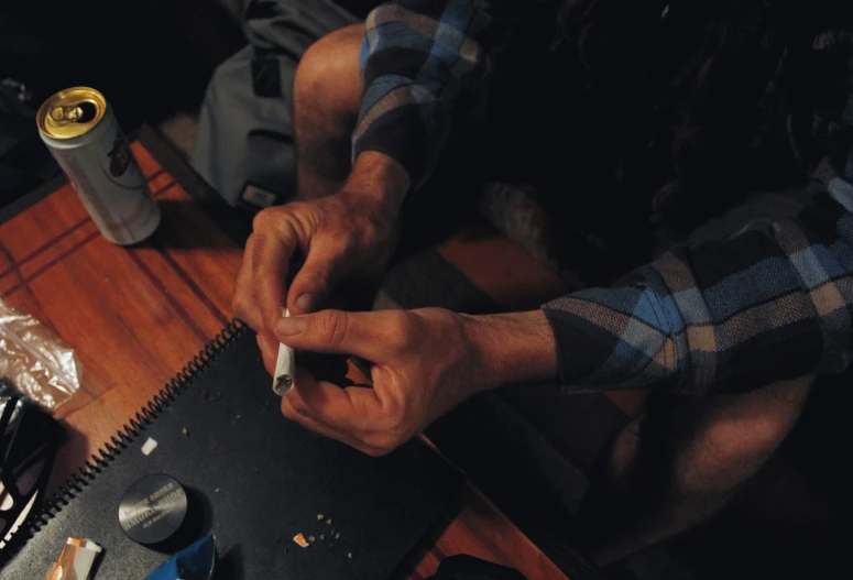 a man doing soing with both hands on a notebook