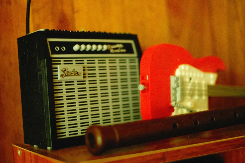 a red speaker sits on top of a table