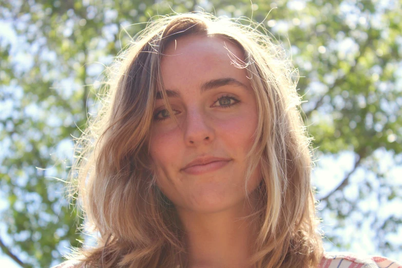 a woman in an outdoor po, looking directly into the camera