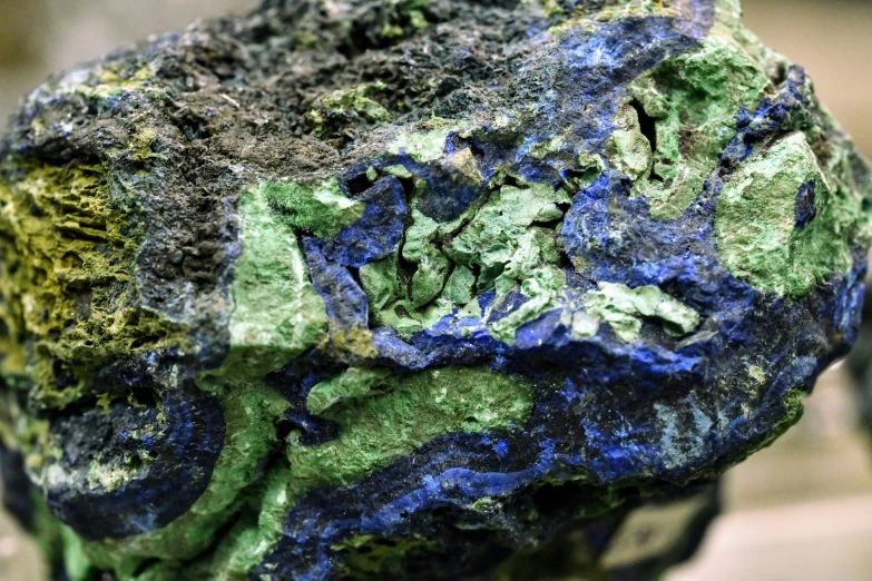 a blue and green rock is made of stone