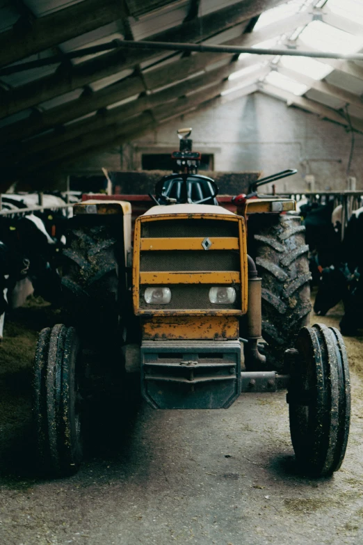 a tractor sits inside of a covered area