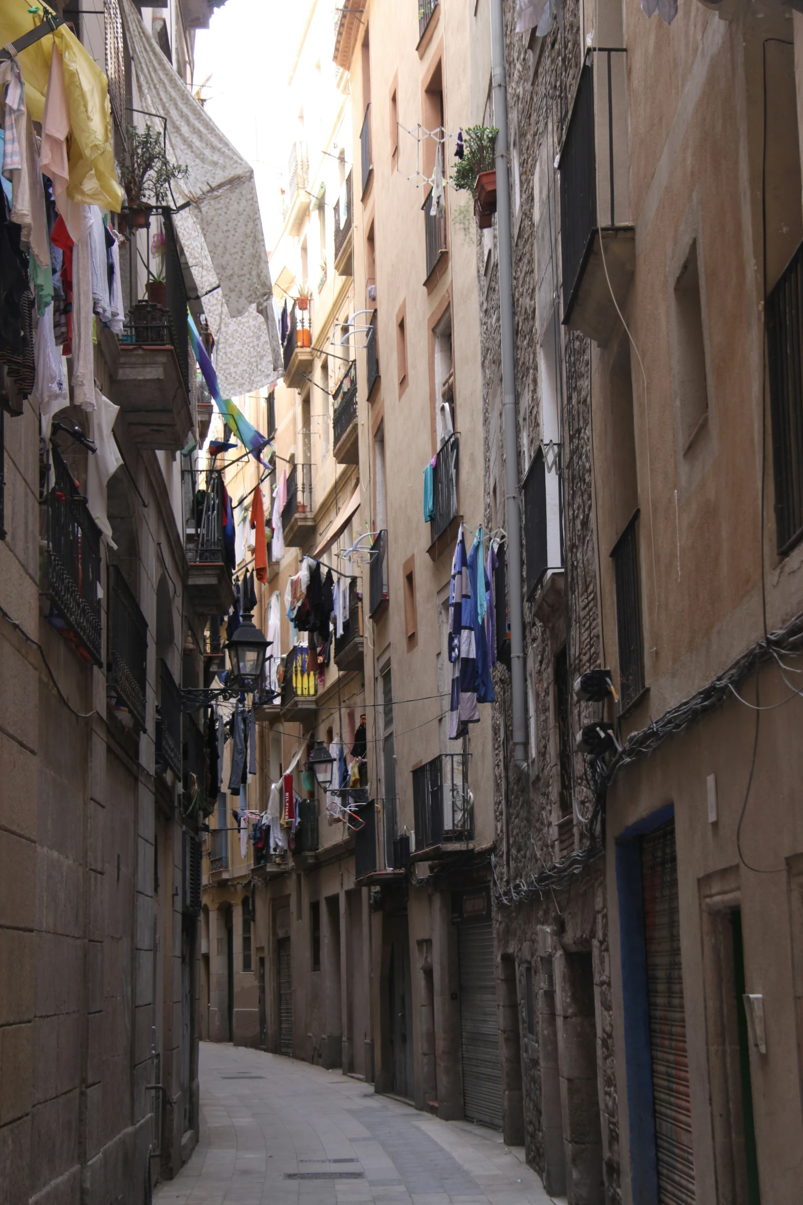 an old alley with lots of laundry hanging from buildings