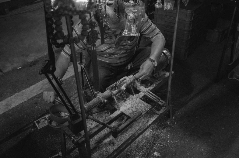 a man riding a stationary machine in a factory
