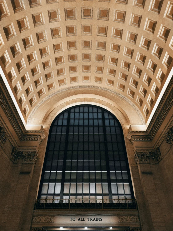 a train station with an entrance lit by the windows