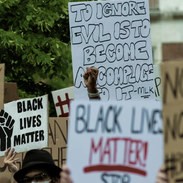 protestors with black lives matter signs holding protest signs