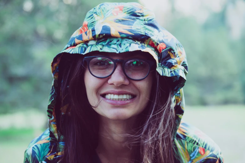 a woman with long hair wearing a hat and glasses