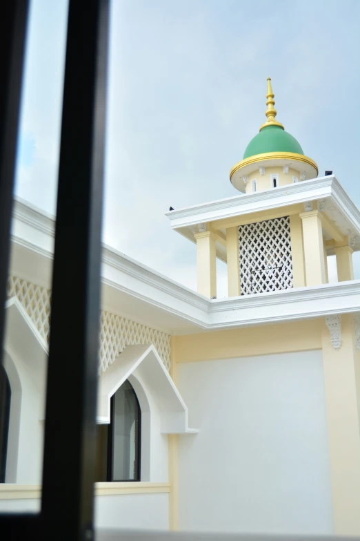 an ornate building is viewed through the open window