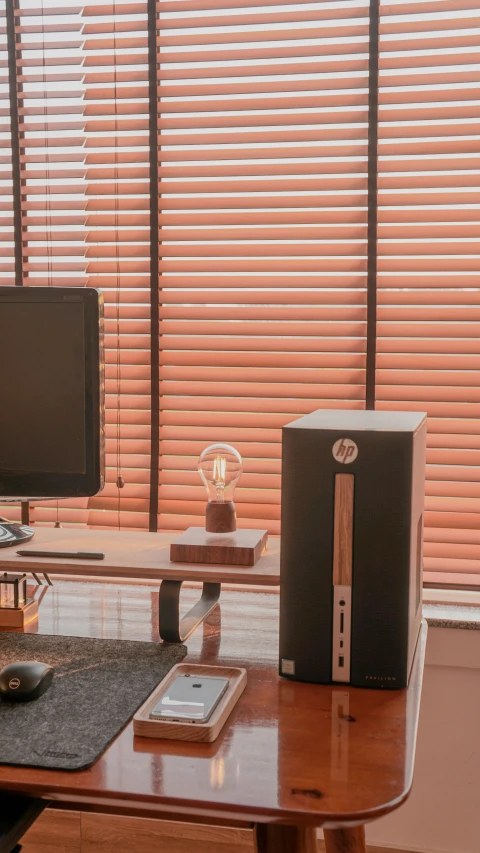 a desk with a computer monitor and laptop, phone and other office equipment