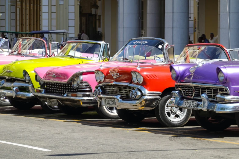 a row of vintage cars on display in a parade