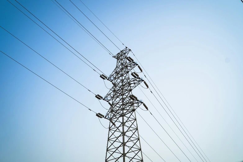 a power pole with lots of wires on top